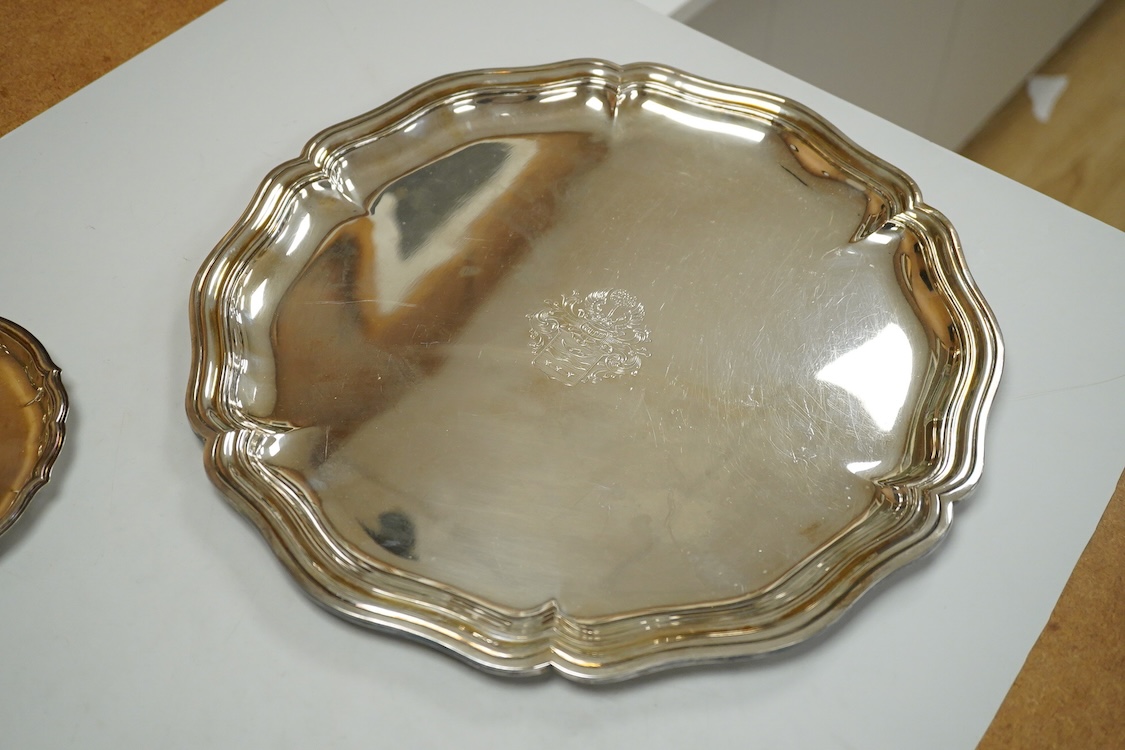 A German 800 standard white metal salver, diameter 35.9cm, together with a similar waiter, diameter 15.6cm, both with engraved armorial, 35oz.